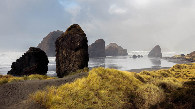 Standing rocks along shore